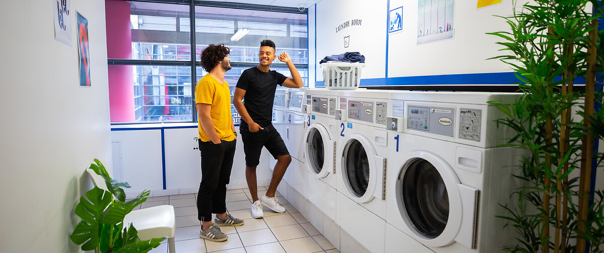 Students talking at the laundry in the student residence Lille Euralille