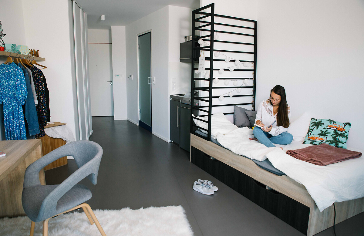 Student or young professional working in her accomodation for students and young professionals at Paris La Defense