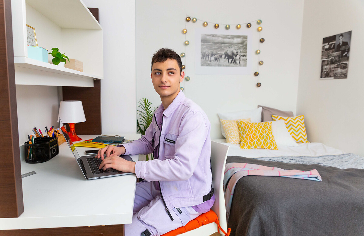 Student working in his student accomodation Paris Palaiseau